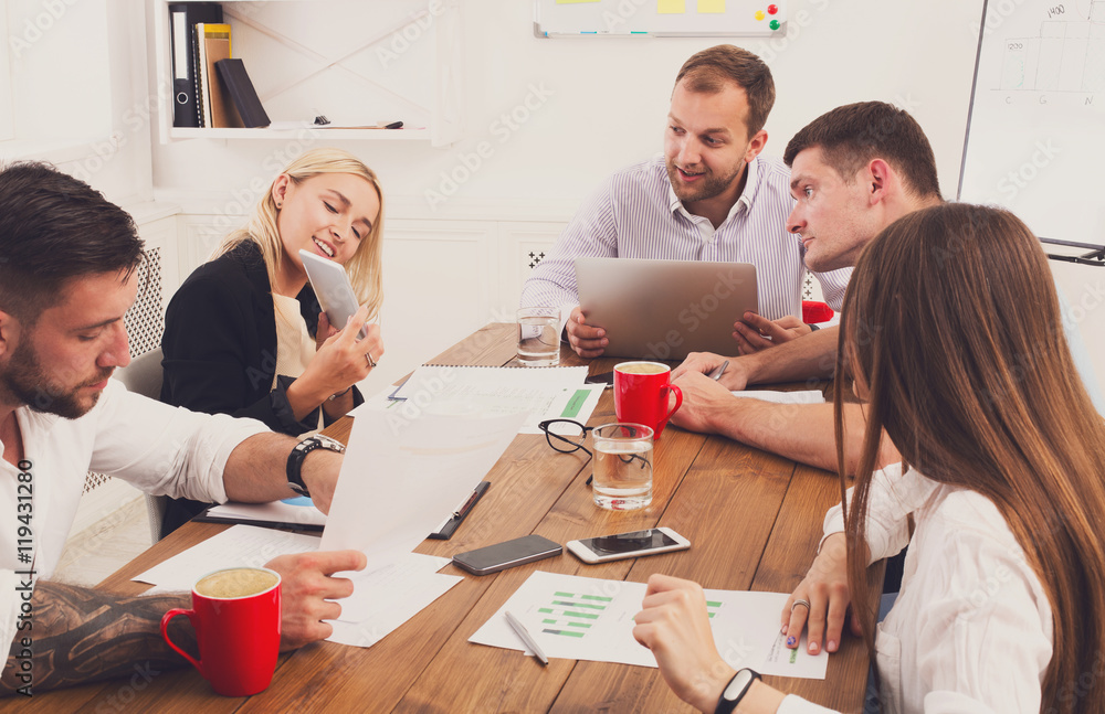 Business meeting. Young hipsters businessmen and women at modern office