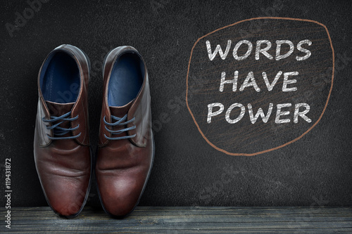 Words have power text on black board and business shoes