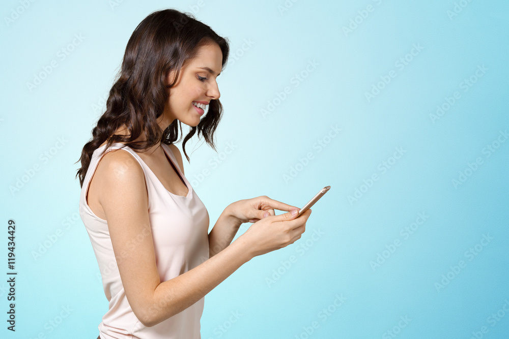 smiling beautiful woman texting with her phone smiling beautiful woman texting with her phone