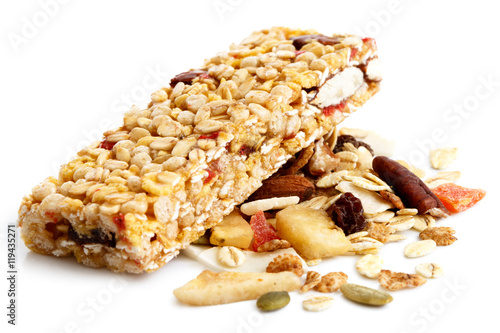 Muesli bar on heap of fruit, seeds and nuts. photo
