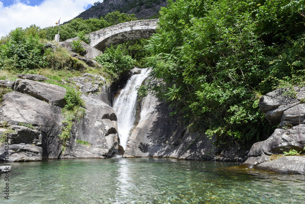 Fototapeta premium Santa Petronilla waterfalls with roman bridge in Biasca