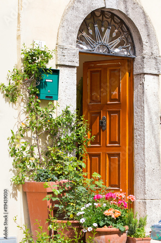 Italian house exterior decorated with potted plants