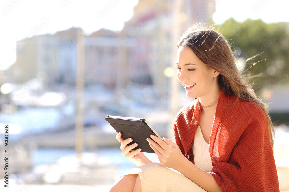 Woman using a tablet watching media content Woman using a tablet watching media content