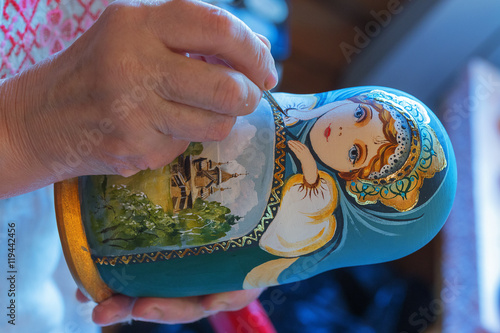 Leningrad region, Podporozhsky District, Russia , June 26, 2016: Painted handmade wooden dolls matreshka - The village of Upper Mandrogi is a reproduction of a traditional Russian village. photo