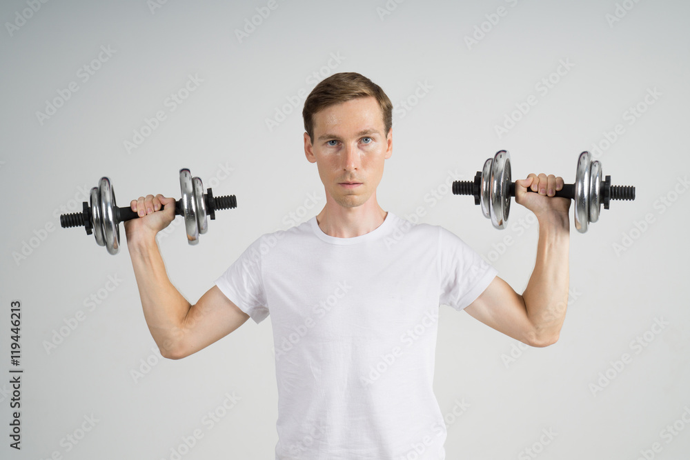 Young Man doing Exercise with Dumbbells. Young Man doing Exercise with Dumbbells.