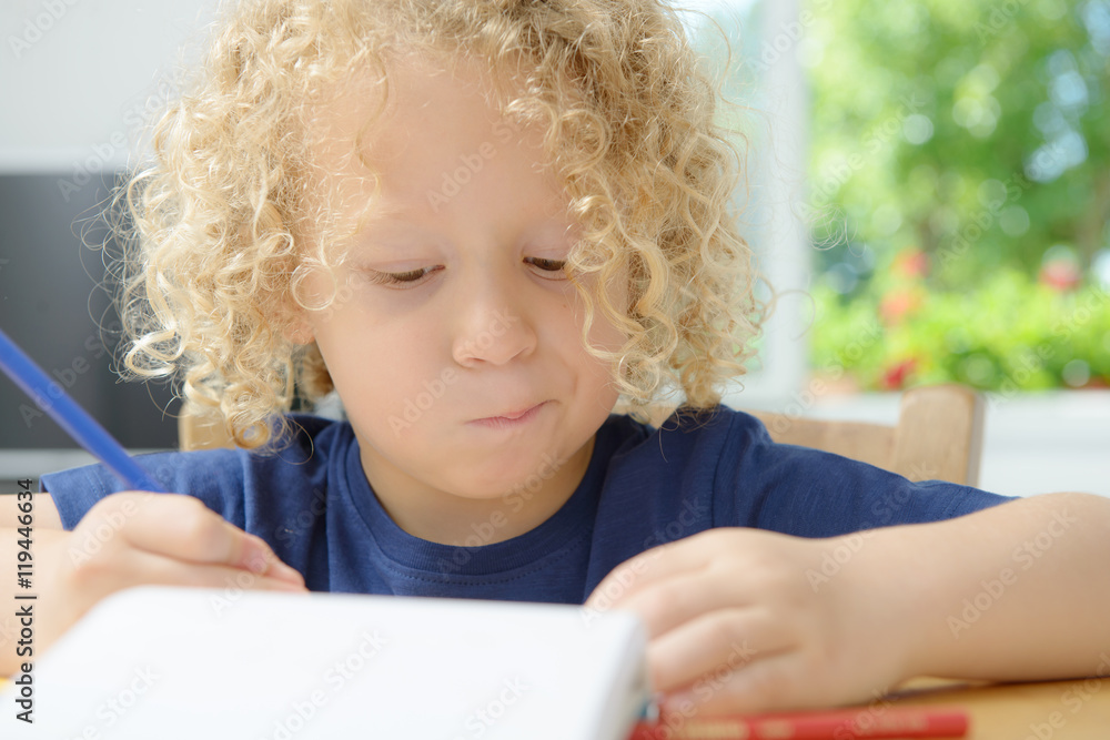 boy drawing on a notebook boy drawing on a notebook