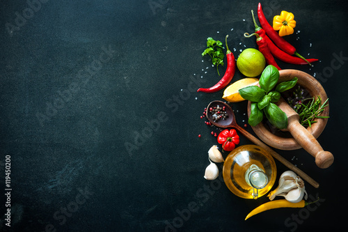 Herbs and spices on slate background