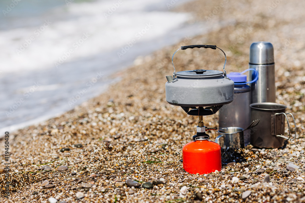 Picnic rest, cooking on the nature. Gas stove, kettle with tea Picnic rest, cooking on the nature. Gas stove, kettle with tea