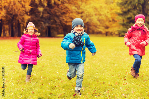 group of happy little kids running outdoors