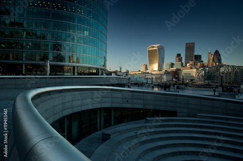 The financial district in London city on the river Thames at sunset. photo