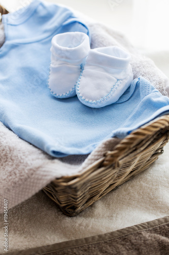 close up of baby clothes for newborn boy in basket
