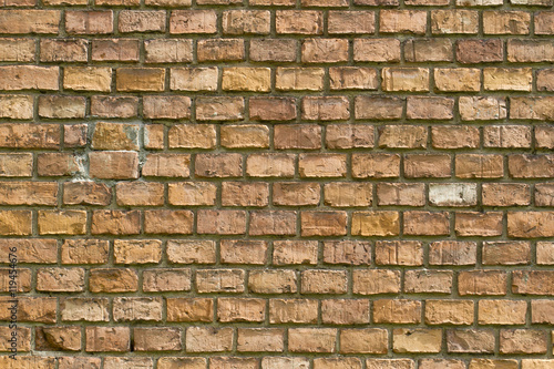 Old vintage red brick wall fragment background texture. Close up