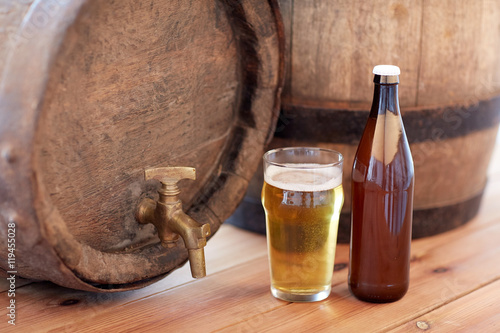 close up of old beer barrel, glass and bottle