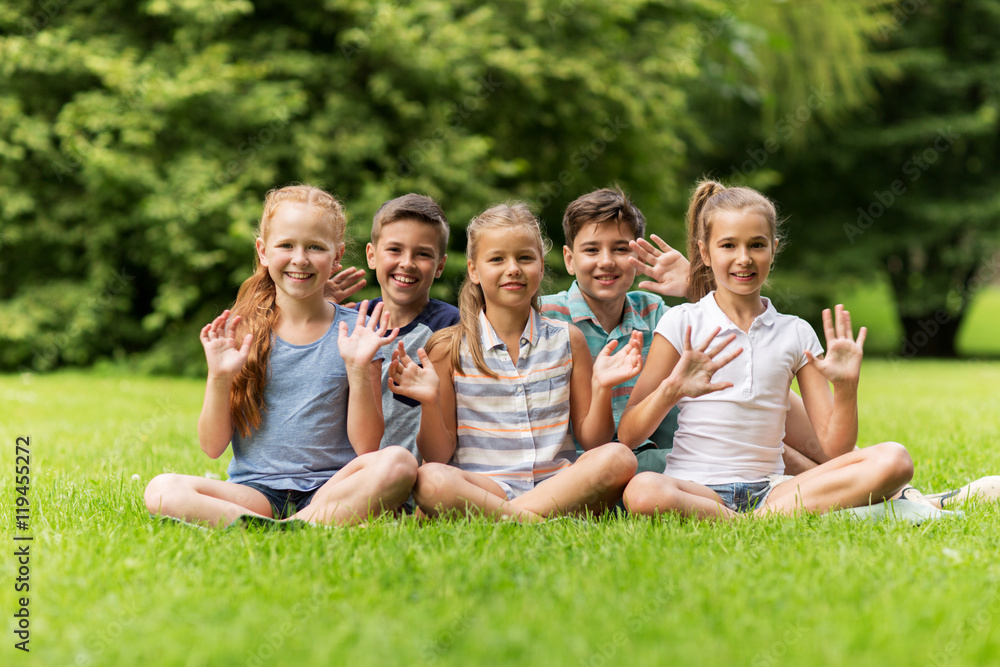 group of happy kids waving hands outdoors group of happy kids waving hands outdoors