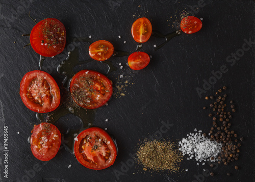 tomatoes cut in half. Cherry tomatoes on cutting board