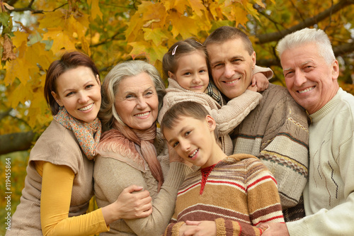 Family relaxing in autumn park