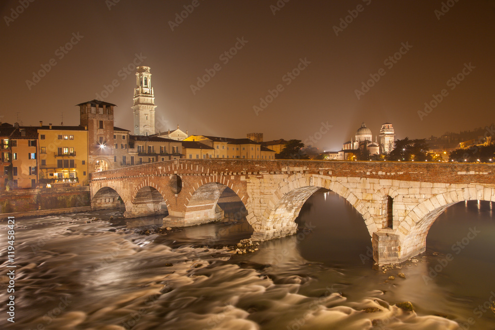 Verona - Pietra bridge at night - Ponte Pietra and Duomo tower and San Giorgio church in background