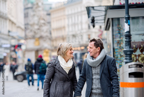 Photography Senior couple on a walk in city centre. Winter