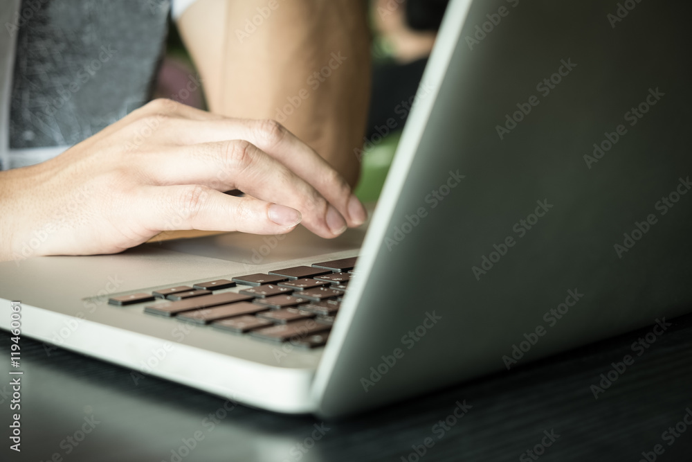 programmer's hand typing with laptop. focus on his finger. programmer's hand typing with laptop. focus on his finger.