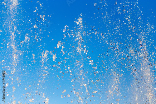 water splashing from the fountain in the background of blue sky