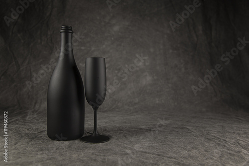 Champagne Bottle and Flute painted flat black on a Mottled Grey Background