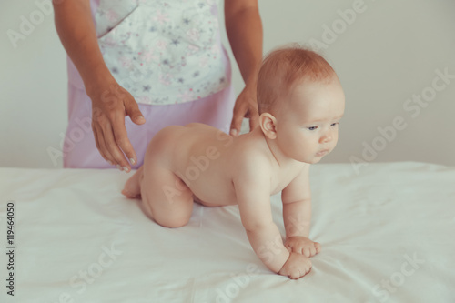 Masseur doing massage a small baby.