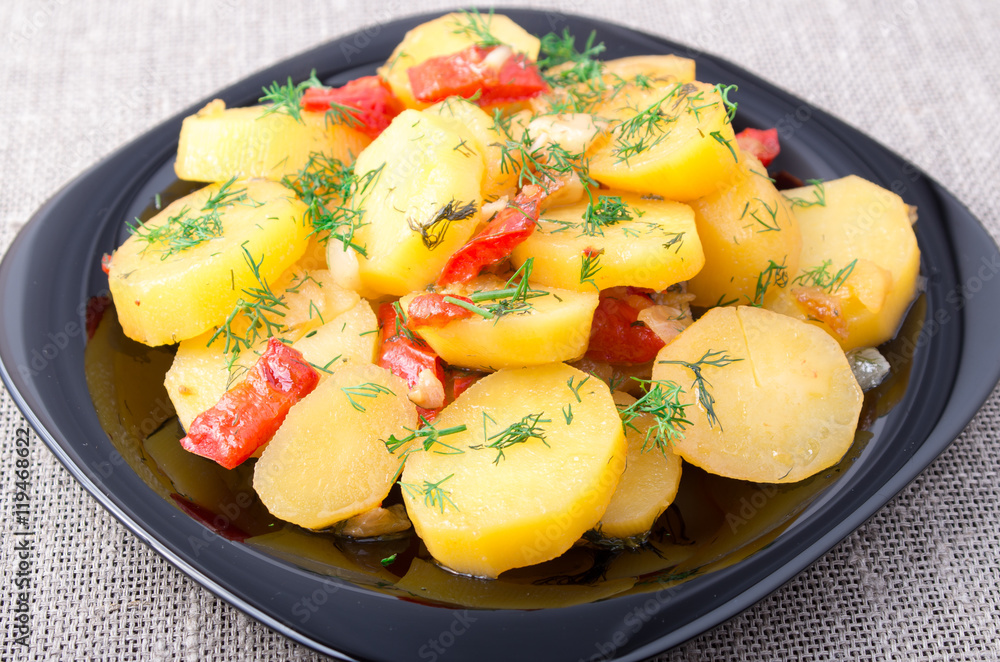 Potatoes with onion, bell pepper and fennel on the surface of th Potatoes with onion, bell pepper and fennel on the surface of th