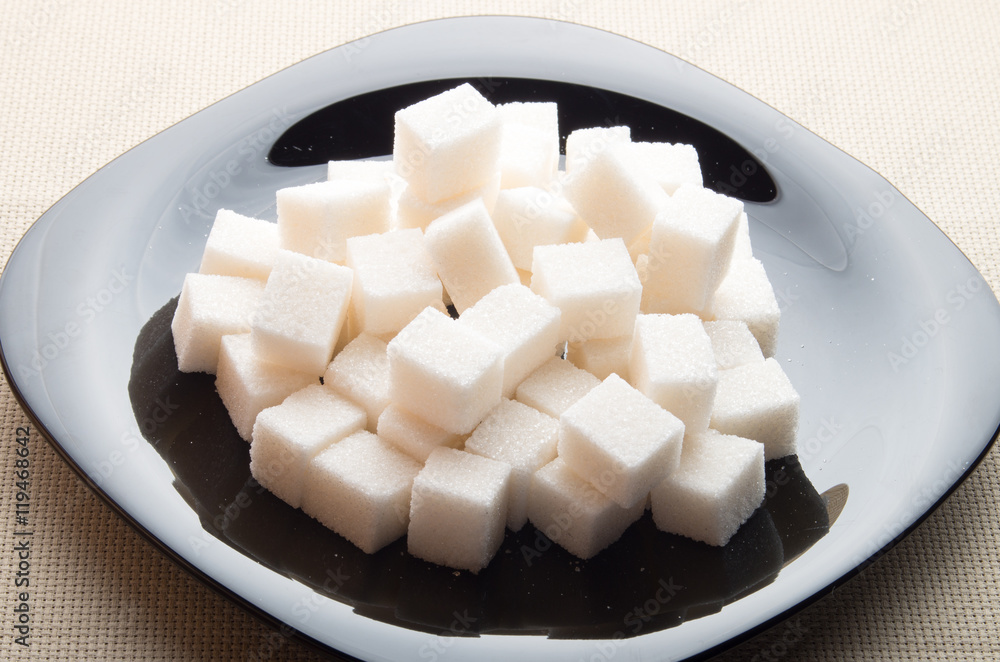Pieces of sugar on a black plate with backlight Pieces of sugar on a black plate with backlight