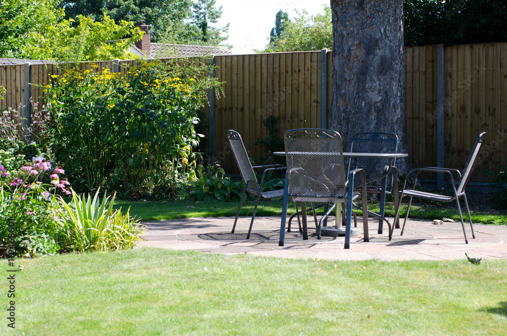 Patio with table and chairs in garden Patio with table and chairs in garden