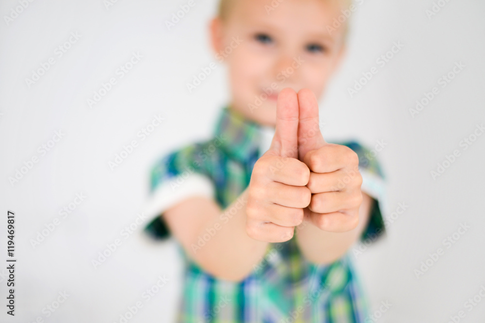 Little boy doing thumbs up for camera, standing at home Little boy doing thumbs up for camera, standing at home