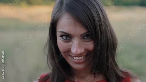 Close-up of attractive young woman smiling at camera