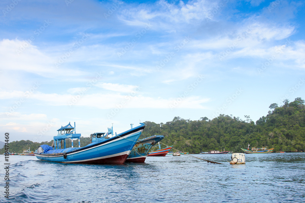 Fototapeta premium Sendang biru beach in the southern part of Malang, east java indonesia with long tail boat, sail boat, and yacht