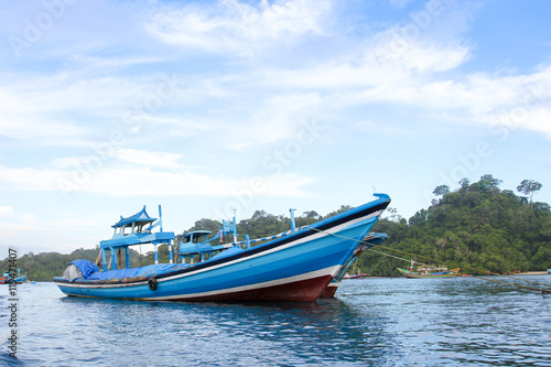 Sendang biru beach in the southern part of Malang, east java indonesia with long tail boat, sail boat, and yacht © junzportraits