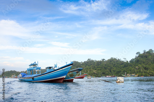 Sendang biru beach in the southern part of Malang, east java indonesia with long tail boat, sail boat, and yacht
