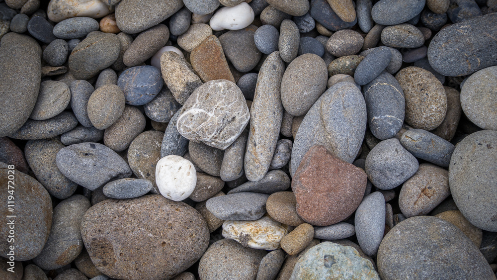 Multicolored pebbles lie on the beach Multicolored pebbles lie on the beach