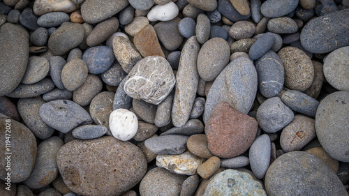 Multicolored pebbles lie on the beach