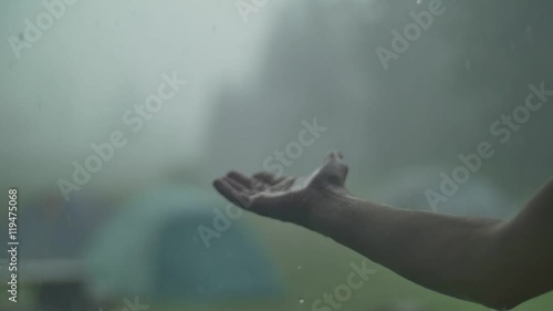 Man hand in the rain and hail