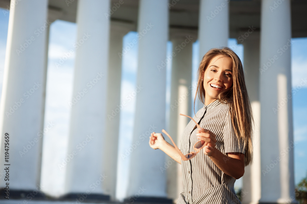 Young beautiful cheerful girl walking around city, smiling, rejoicing. Young beautiful cheerful girl walking around city, smiling, rejoicing.