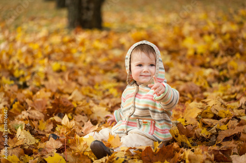 Small girl in autumn park