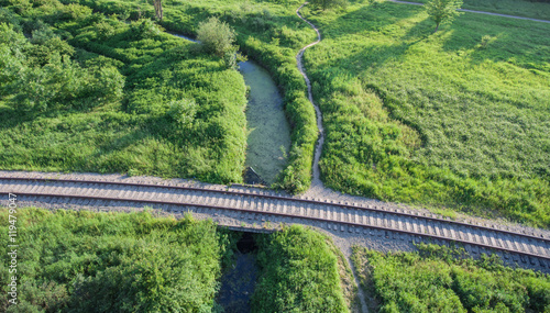 Aerial view of the village railway going across the bridge. Ditc