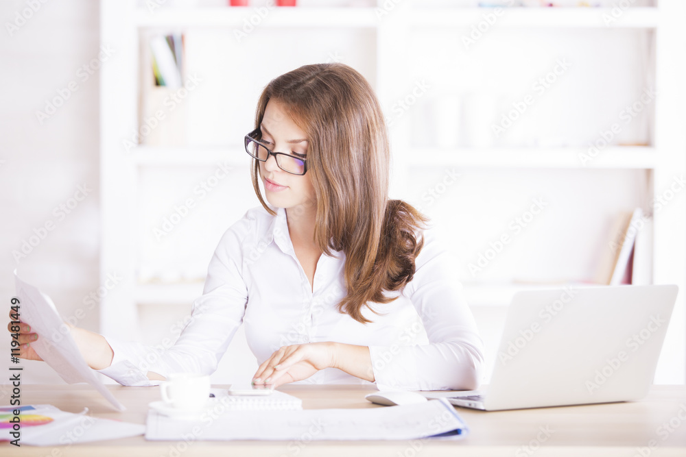 Young woman dealing with paperwork Young woman dealing with paperwork
