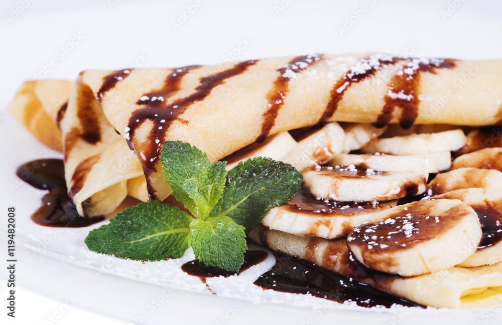 Pancakes stuffed bananas and chocolate on a plate Pancakes stuffed bananas and chocolate on a plate
