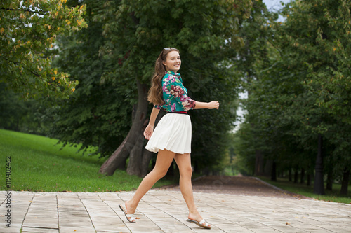 Young brunette woman in white skirt © Andrey_Arkusha