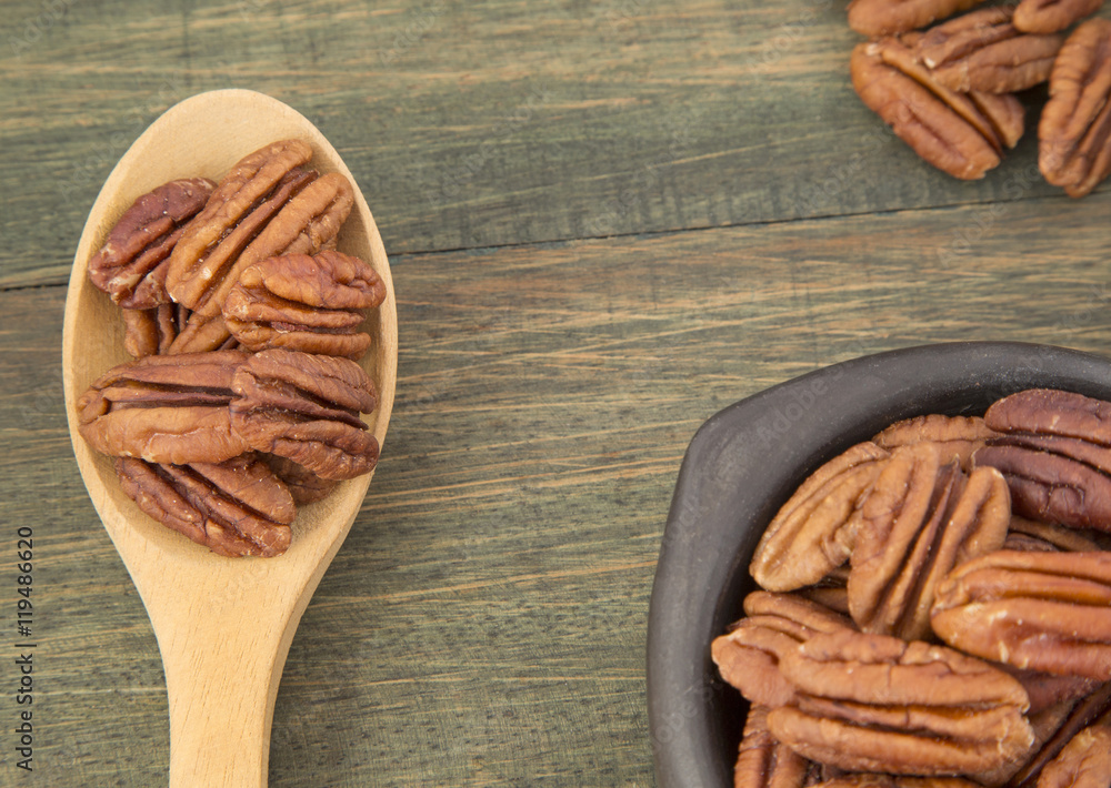 Pecan nuts on a wooden table Pecan nuts on a wooden table