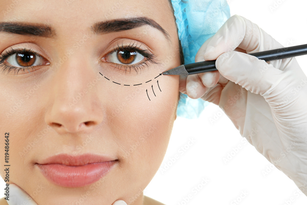 Plastic surgery concept. Hands in gloves marking woman face Plastic surgery concept. Hands in gloves marking woman face