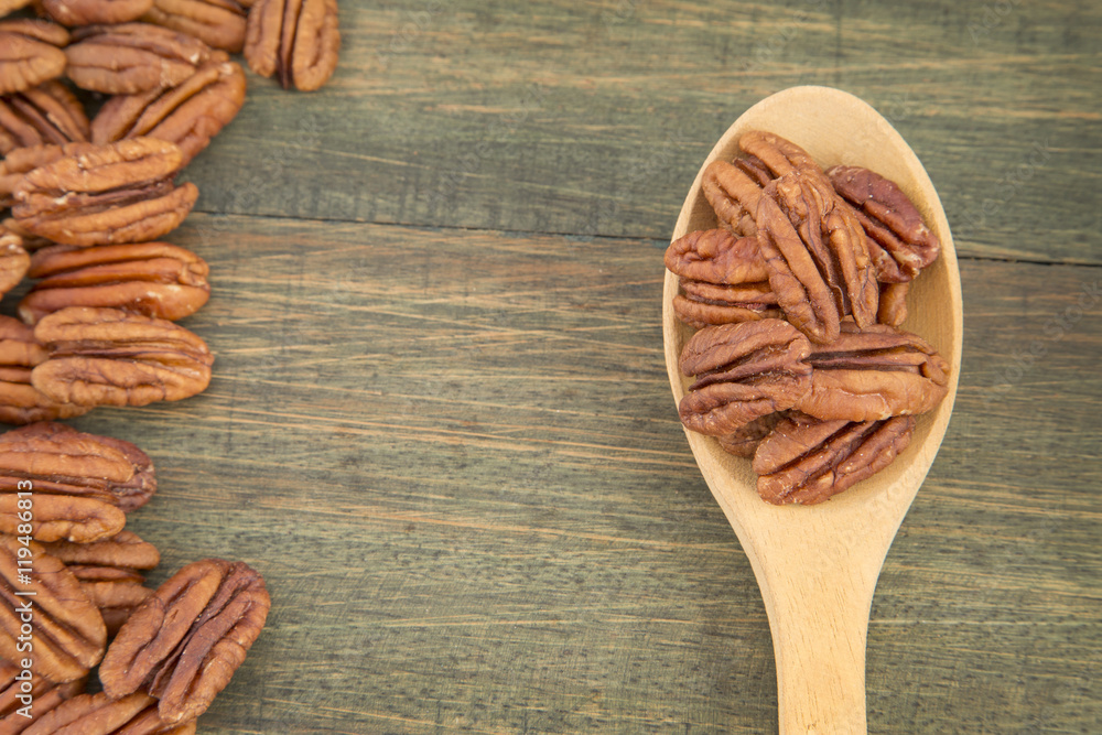 Pecan nuts on a wooden table Pecan nuts on a wooden table