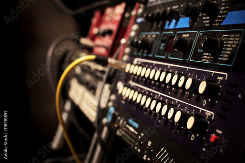 recording studio gears in rack, focus to knob & shallow dept of field