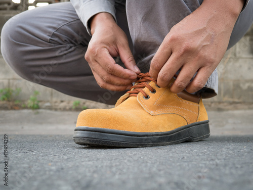 Man wears safety shoes on street