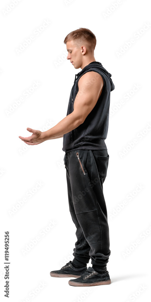 Side view of muscled young man holding something in his hands, isolated on white background Side view of muscled young man holding something in his hands, isolated on white background