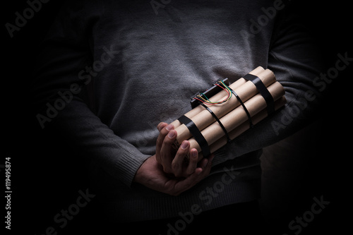 man in a black jacket strapped with explosives and detonator hol © aradaphotography
